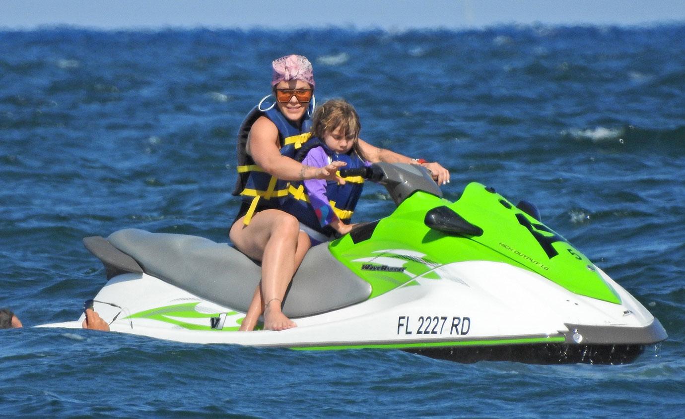 Pink and her adorable family ride some Jet Skis on the Beach in Florida