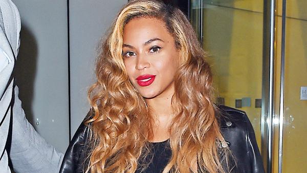 Beyonce shows off her legs in a black dress with a high split as she seen smiling while leaving her Midtown office, NYC