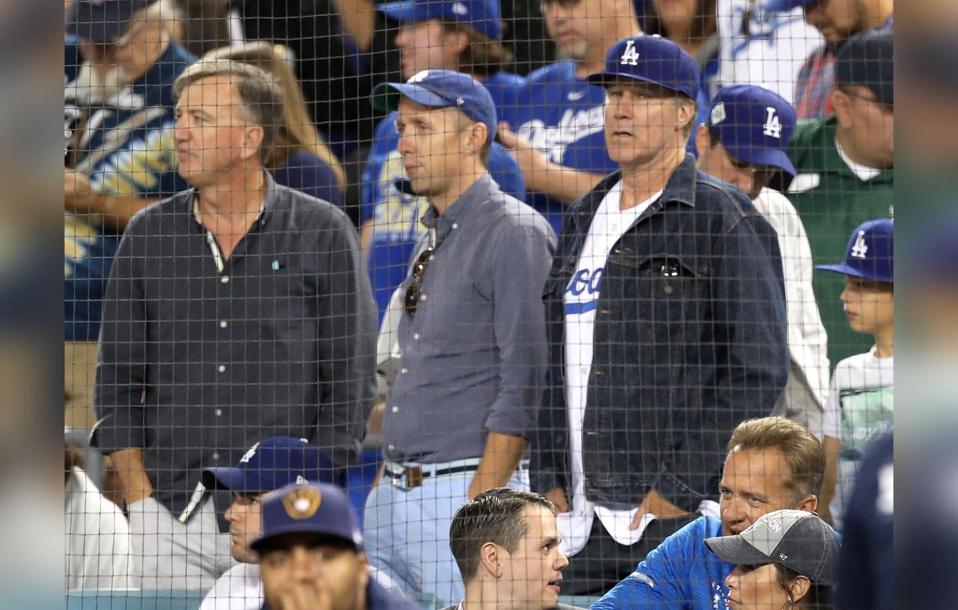 Actor Will Ferrell, at podium, points toward Los Angeles Dodgers