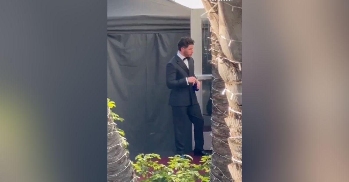Image of Nick Jonas hung out solo at the awards show.