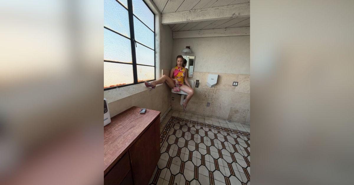 image of Gabby Windey shared a playful bathroom photoshoot wearing a colorful retro-inspired mini dress and metallic heels.