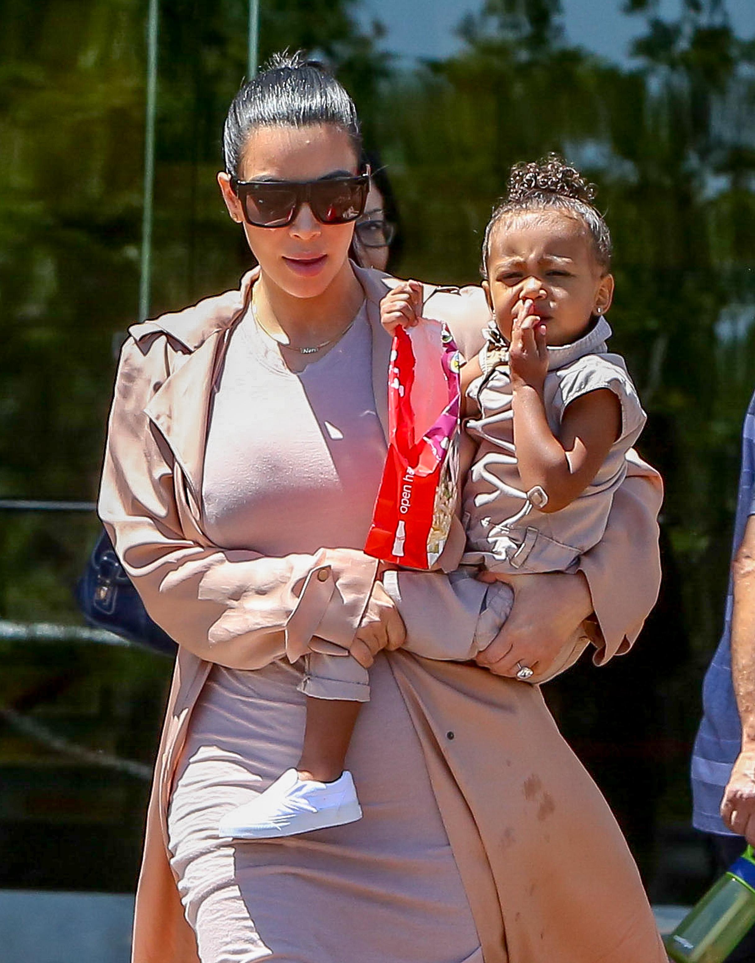 Kim Kardashian and Kanye West take their baby North West to the movies in Calabasas, CA