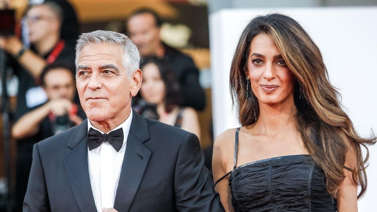 image of Amal Clooney needed a helping hand while carefully making her way down the boat's steps but appeared unfazed by the moment.
