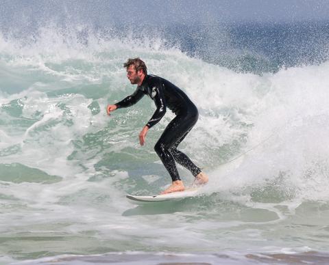 Almost-Naked Liam Hemsworth Shows Off His Pecs And Abs While Surfing In