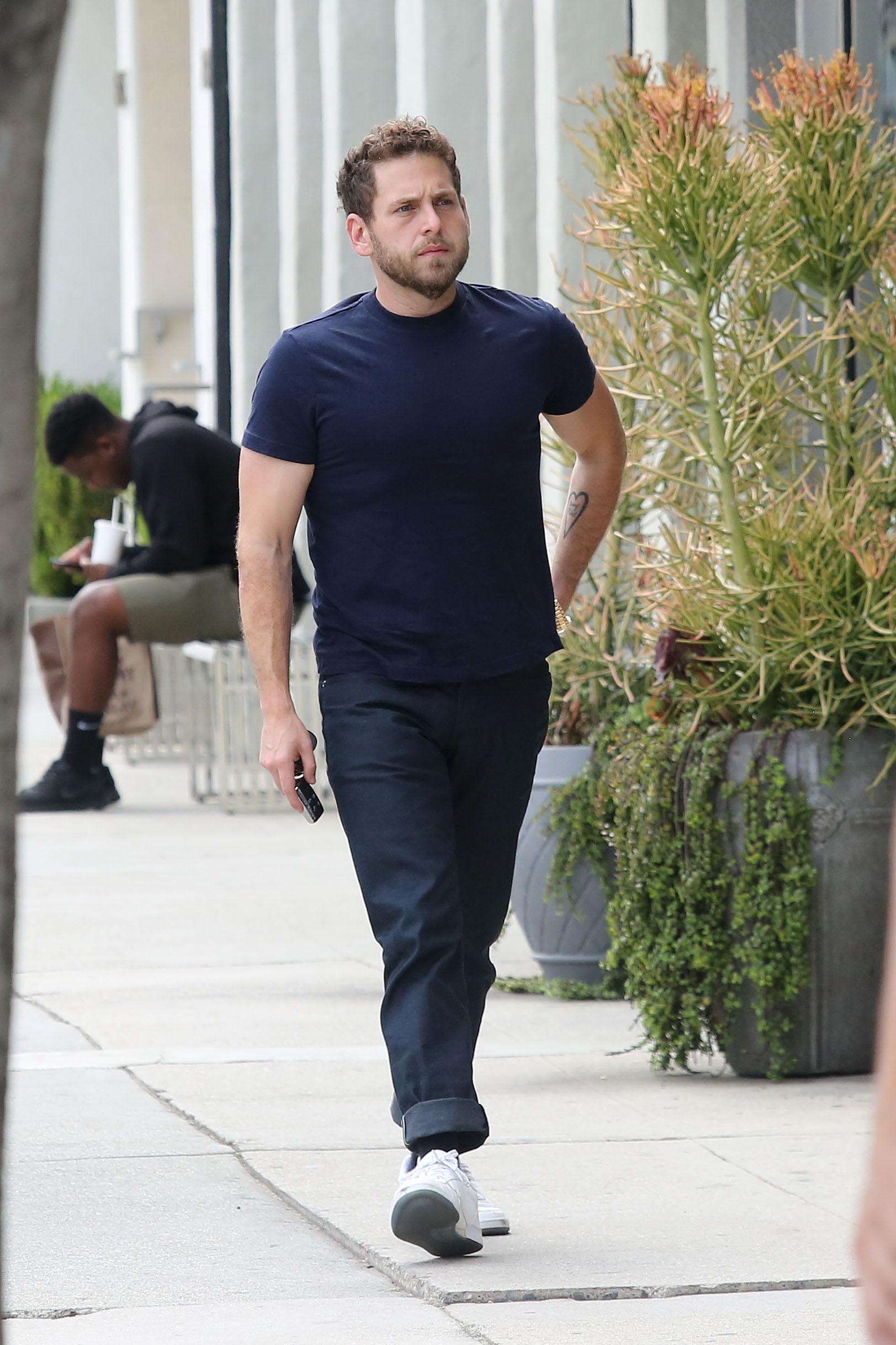 EXCLUSIVE: Jonah Hill shows off his guns in a tight fitted T shirt