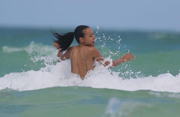 Karrueche Tran shows off her beach body in a white swimsuit while enjoying  a fun day