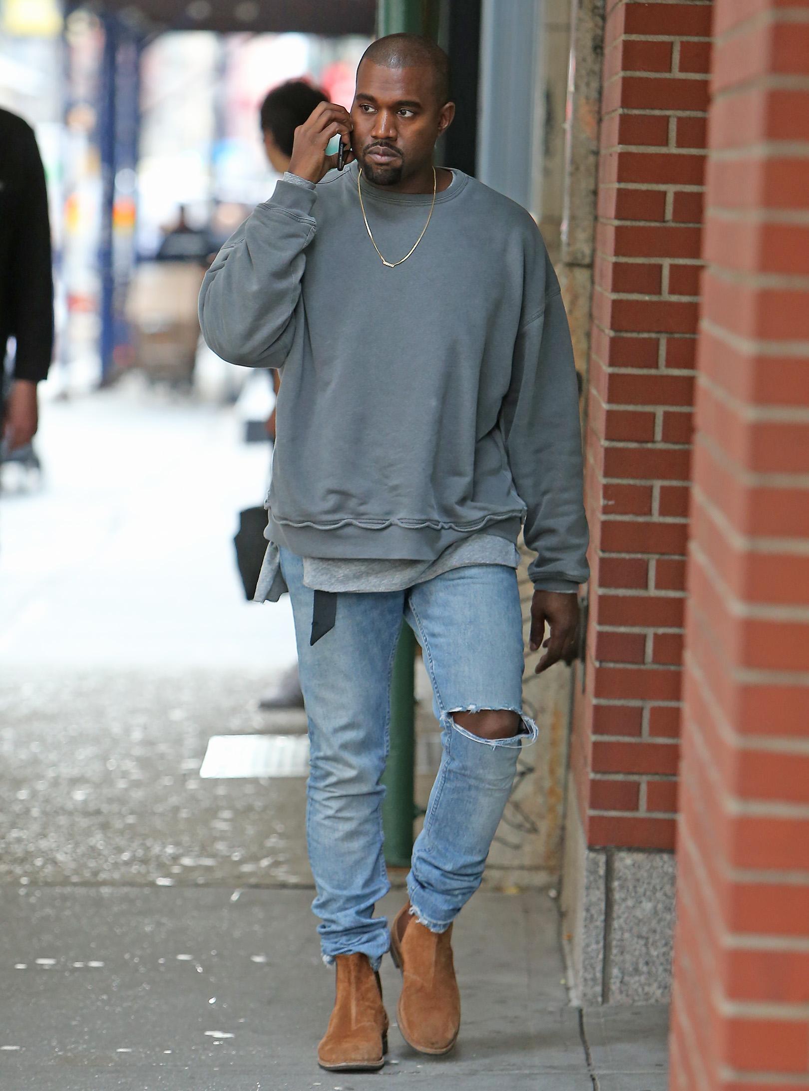 Kanye West wears grills on his bottom teeth out in Soho, NYC