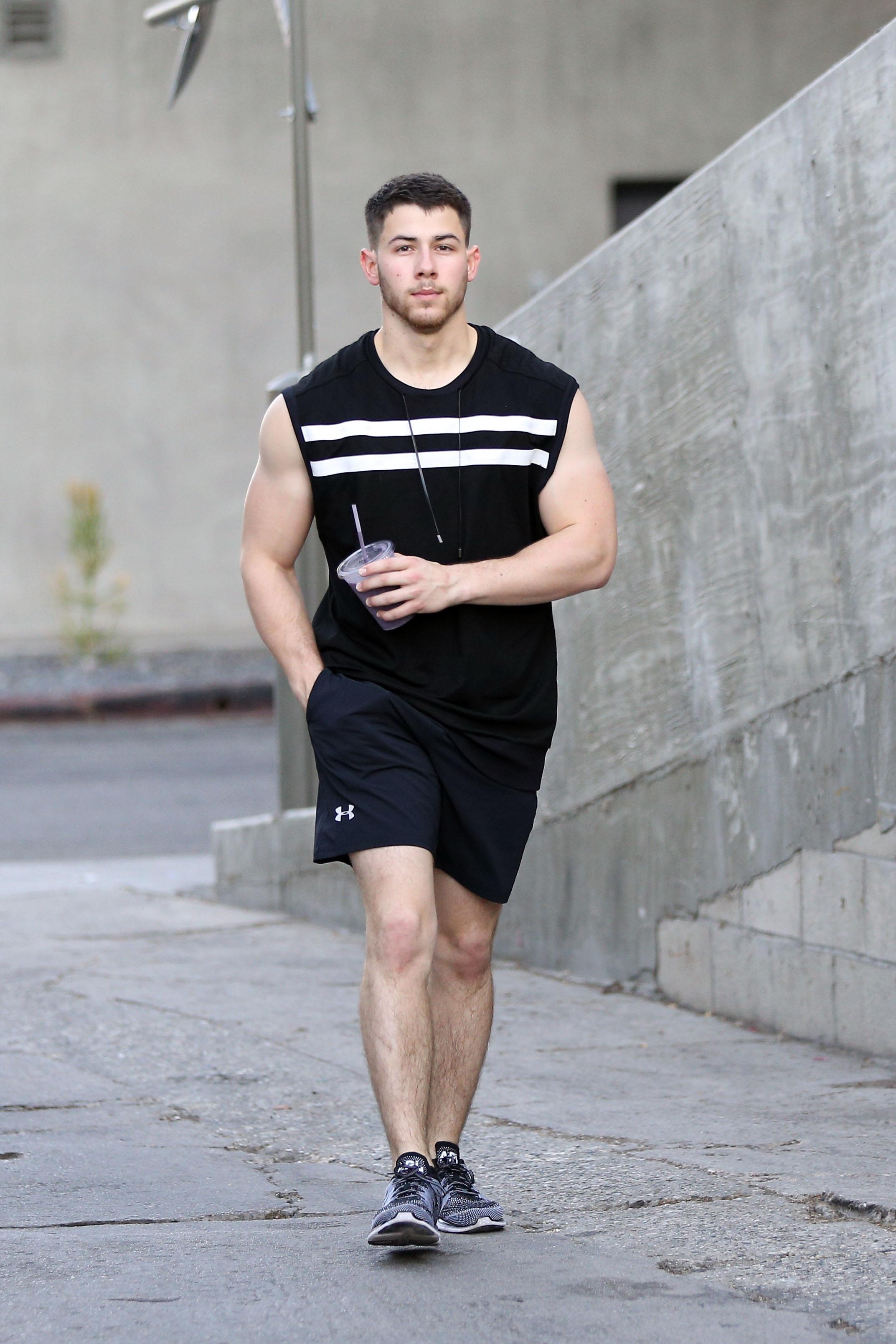 Nick Jonas shows off his guns at the gym