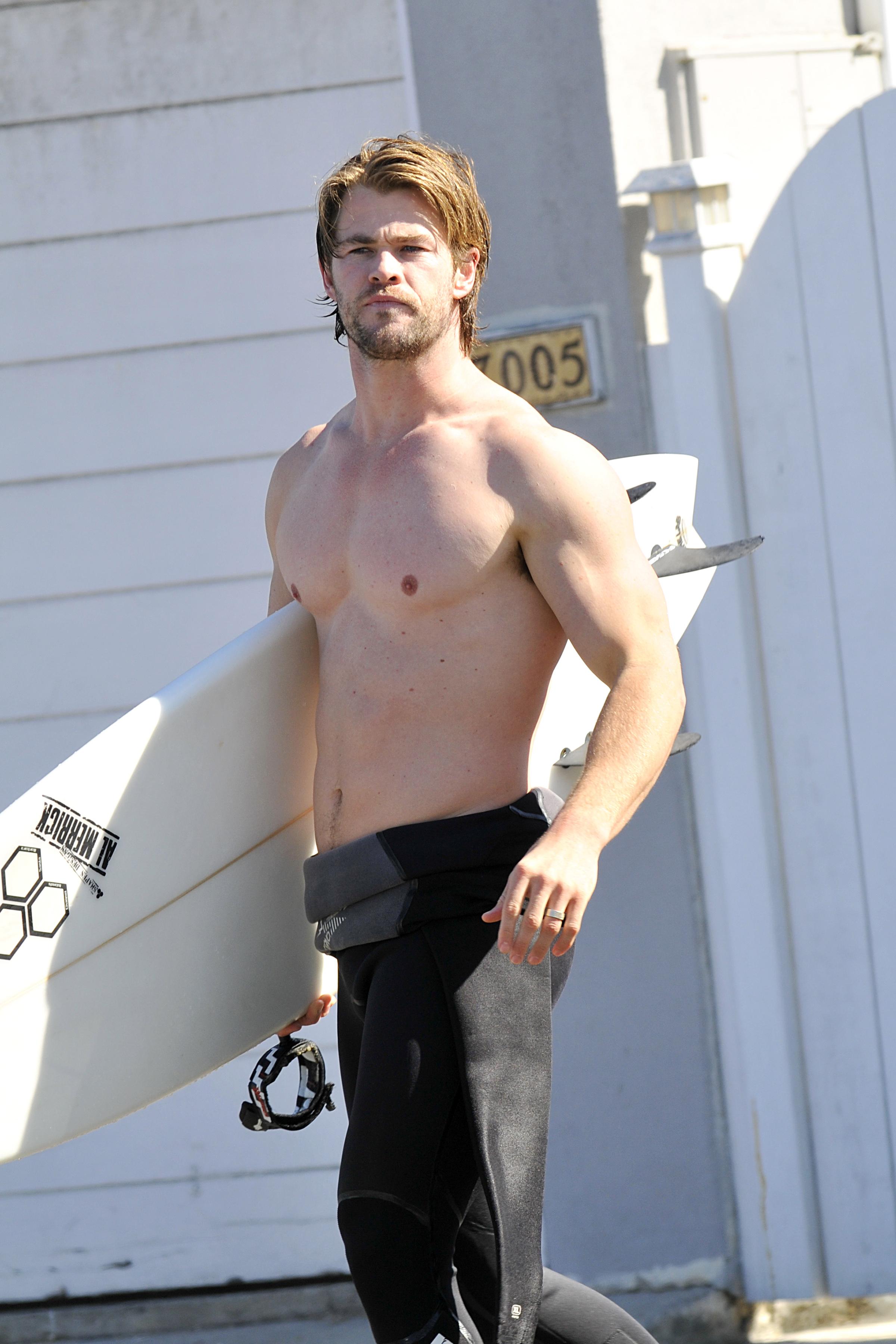 EXCLUSIVE: Chris Hemsworth changes his oil and goes for a surf after having lunch with his wife Elsa Pataky in Newport Beach, CA