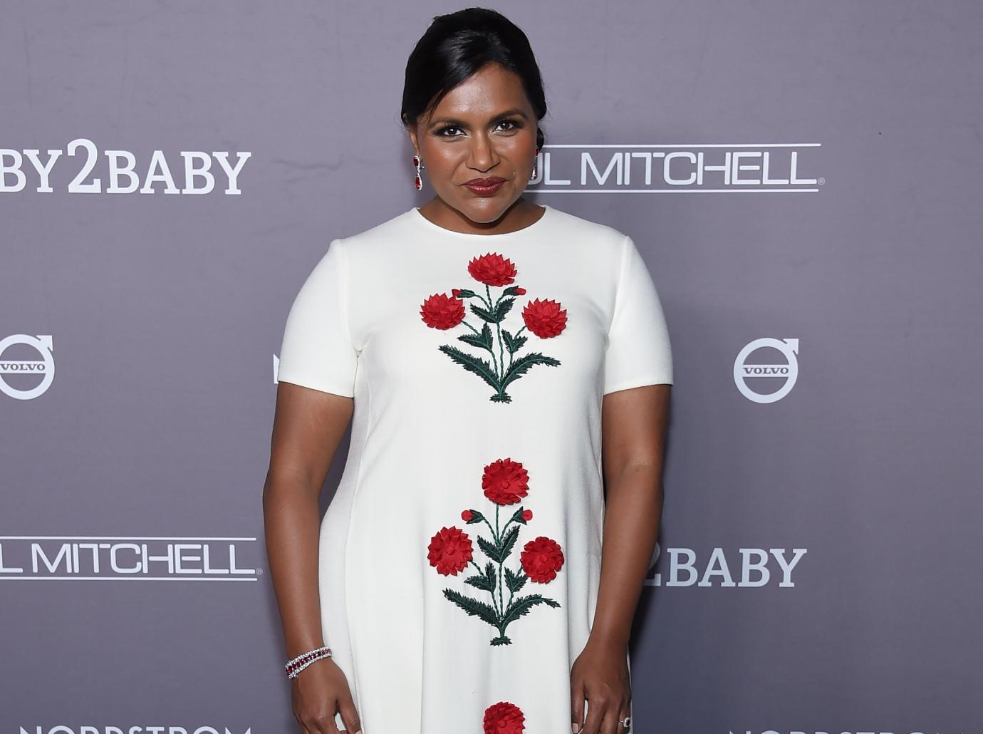 Mindy Kaling flashes her bra on a break from filming The Mindy Project