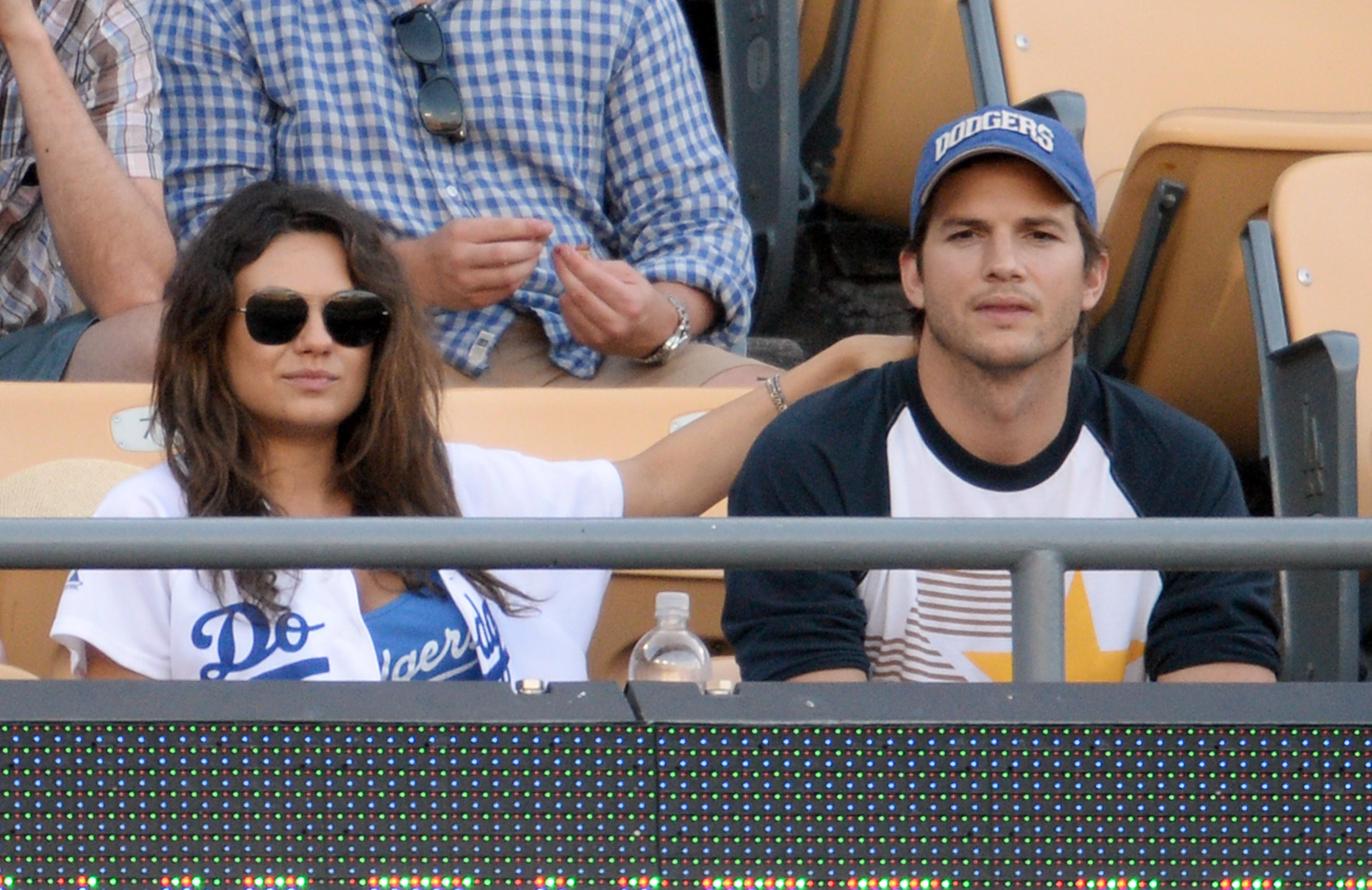 Mila Kunis and Ashton Kutcher kiss at LA Dogers v St Louis Cardinals, Los Angeles