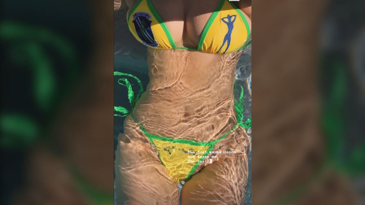 image of The influencer stunned while posing waist-deep in the sparkling pool.