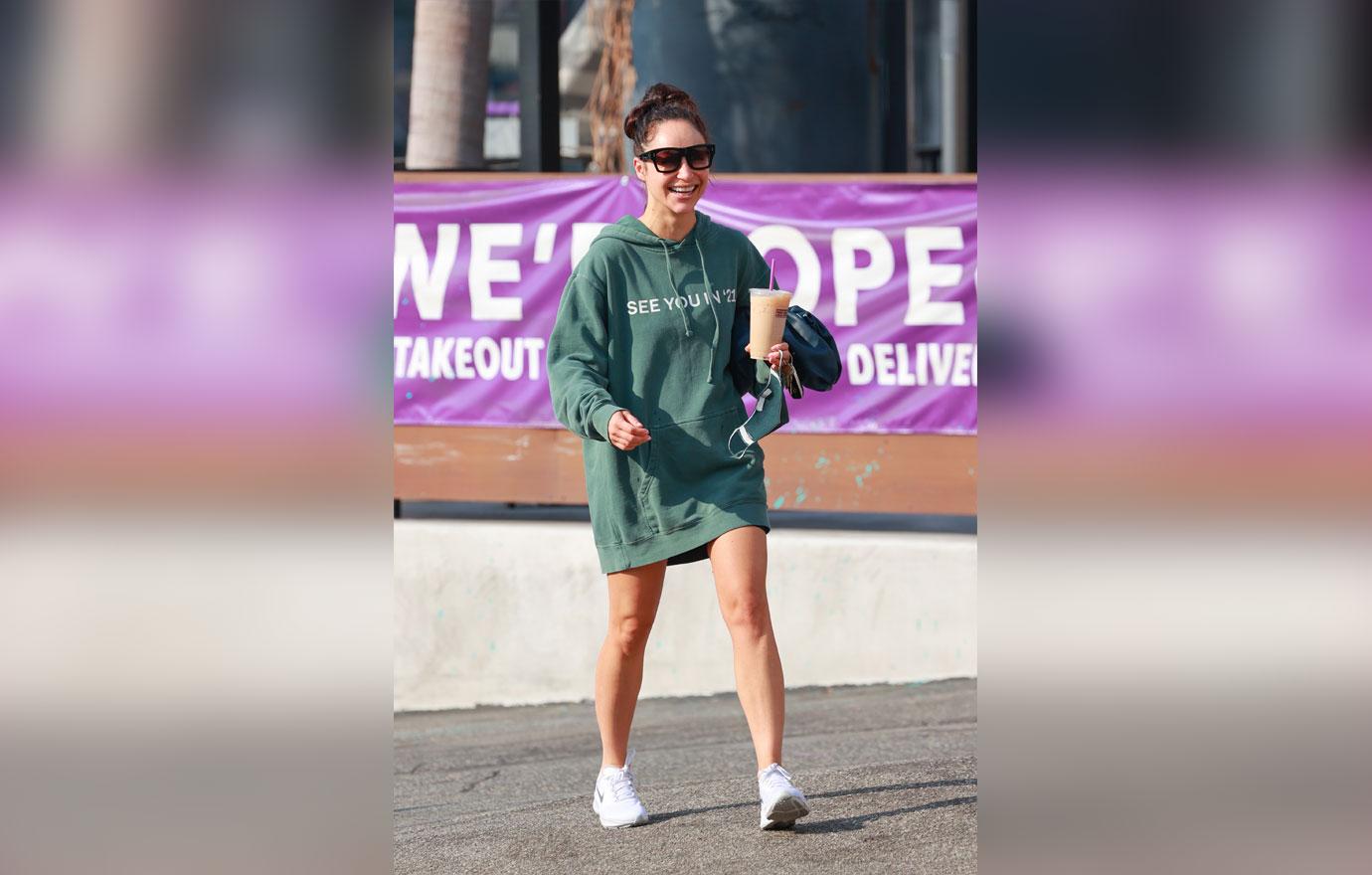 Cara Santana rocks a “see you in ‘21” Hoodie as she grabs an iced coffee after the gym. The top Made by Thirty Seconds of Mars