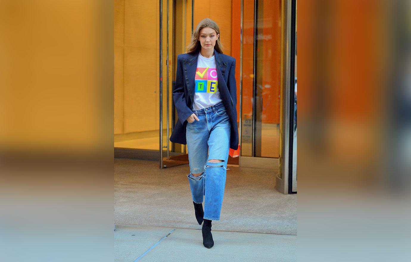 Gigi Hadid is all smiles showing off her VOTE t shirt as she leaves Victoria Secret fashion show fittings in NYC