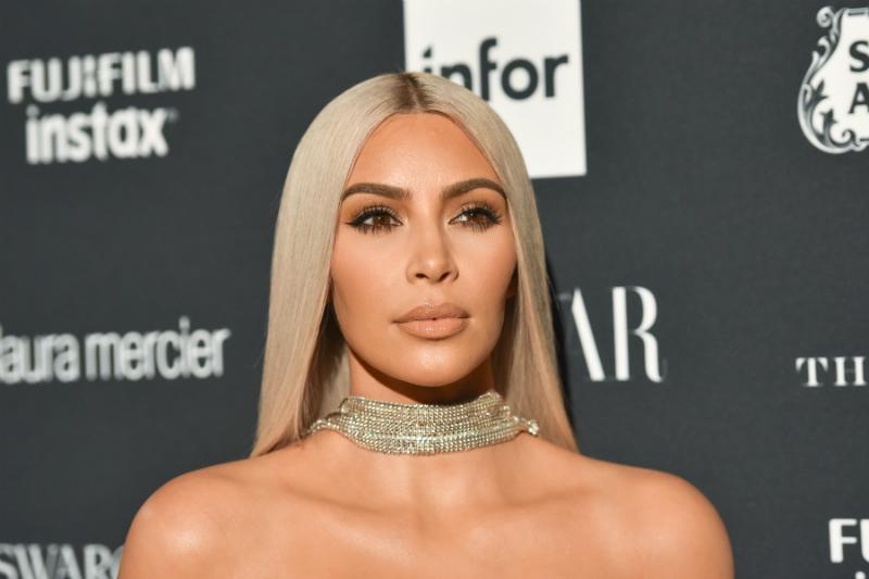 Kim Kardashian wears a silver choker and long straight blonde hair in this photo taken at a 2017 New York City event.