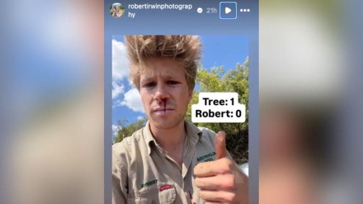 image of Robert Irwin examined large crocodile footprints while documenting his annual wildlife research expedition.