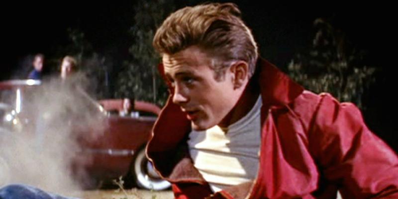 James Dean smoldered in his classic red jacket and white T-shirt in a scene from his triumphant film, Rebel Without a Cause.