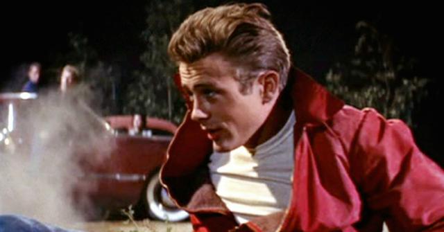 James Dean smoldered in his classic red jacket and white T-shirt in a scene from his triumphant film, Rebel Without a Cause.