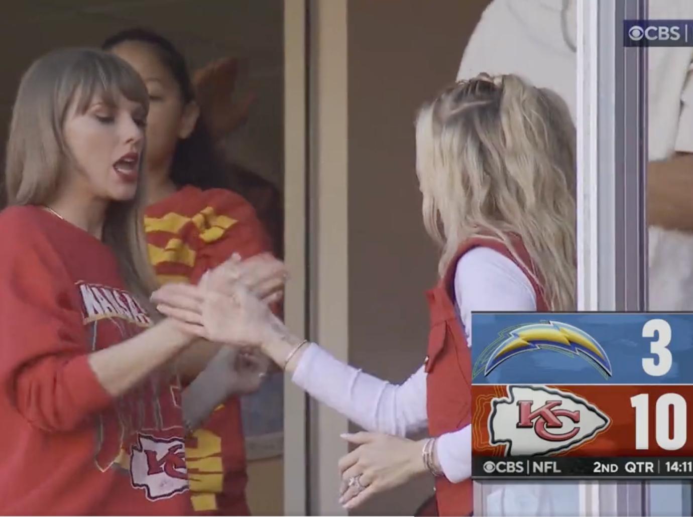 Taylor Swift & Travis Kelce Hold Hands While Leaving Chiefs Game