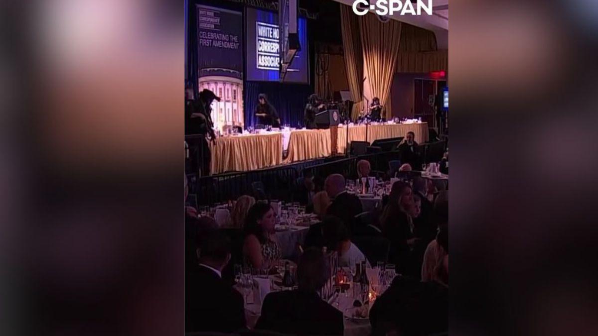 image of Donald Trump was escorted from the event. 