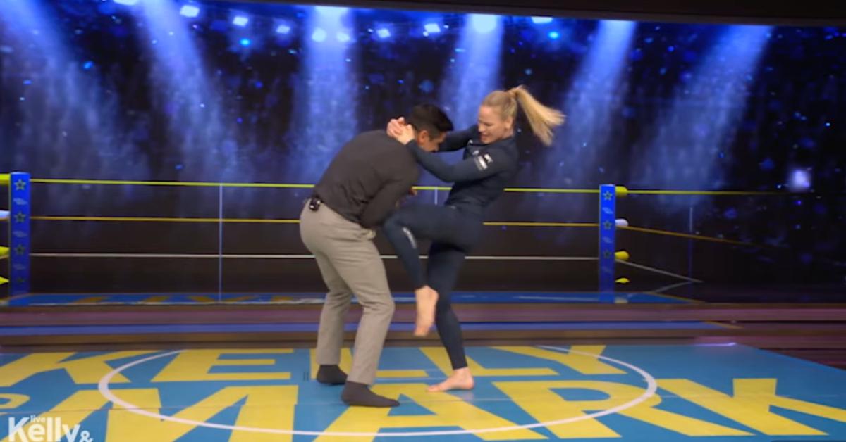 Image of UFC champion Valentina Shevchenko pretended to knee Mark Consuelos in his guts.