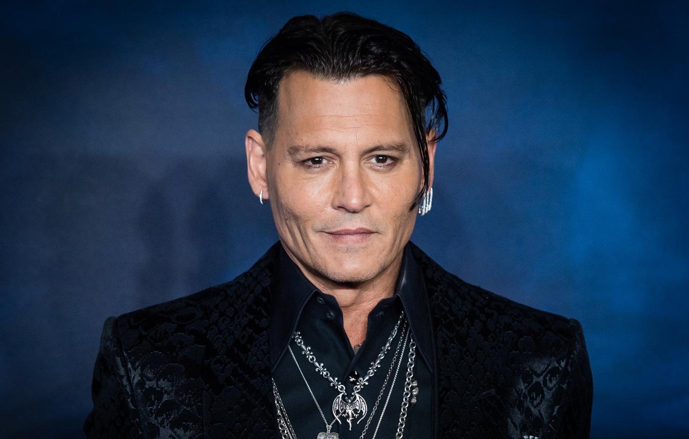 Johnny Depp poses at the red carpet at an event