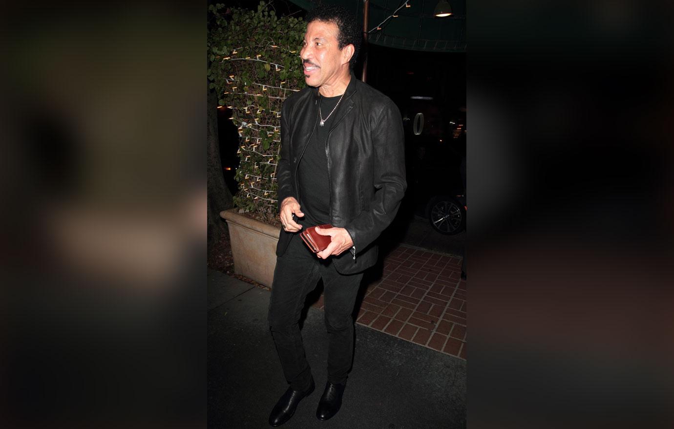 Lionel Richie smiles as he heads into Madeo restaurant