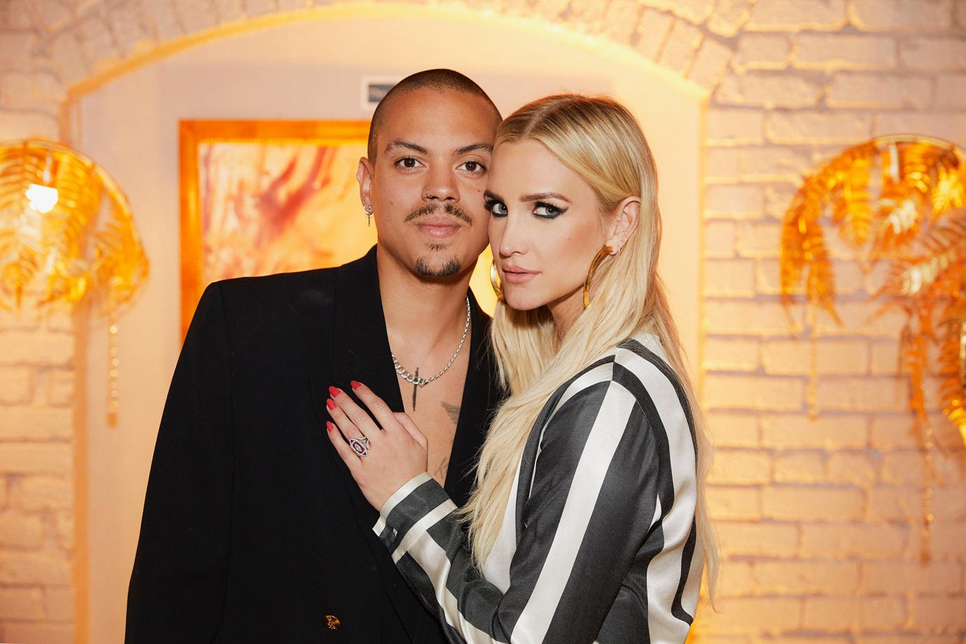 Evan Ross In Black Suit Smiles With Ashlee Simpson in Striped Blouse