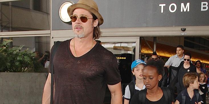 Brad Pitt and Angelina Jolie arriving on a flight at LAX with their children