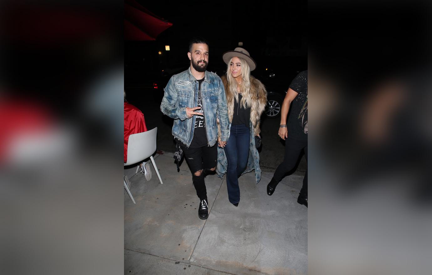 Mark Ballas Wears a jean Jacket and Ripped Jeans and Holds Hands With Wife BC Jean who Is Wearing a Fur Coat and Hat