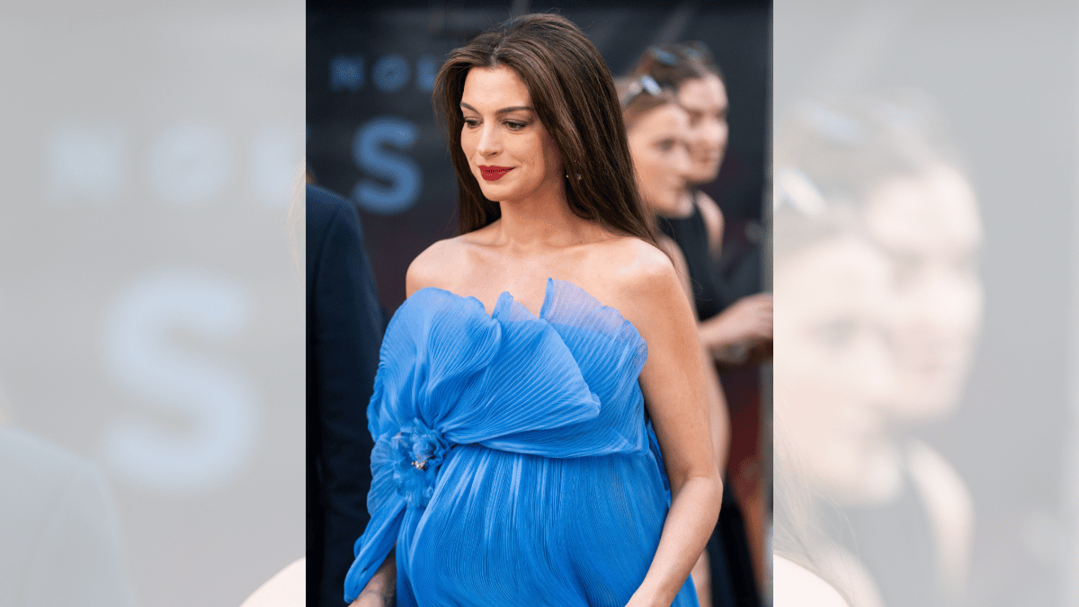 Image of days before this premiere, Hathaway showcased her growing baby bump in a flowing white dress during 'The Odyssey' photocall.