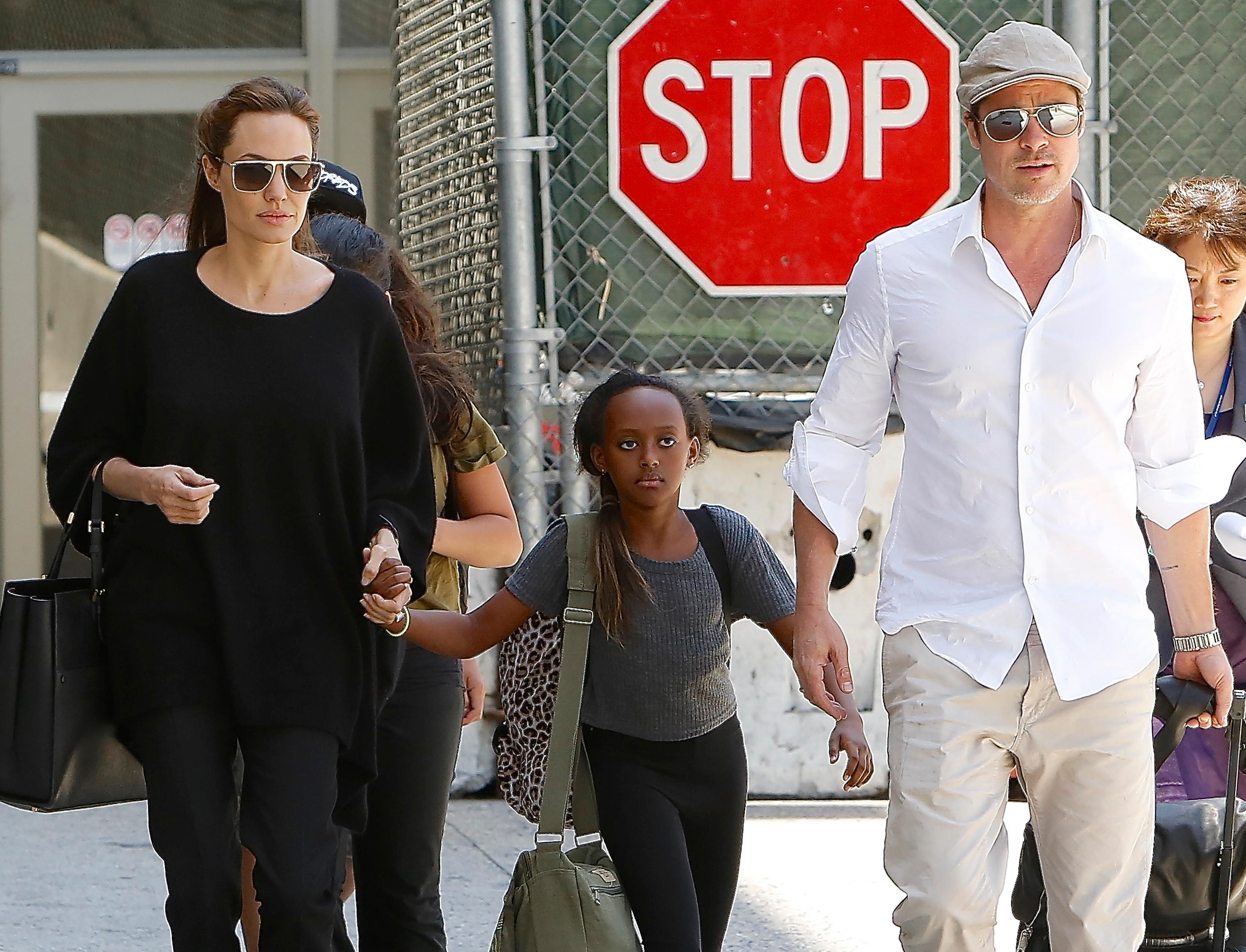 Angelina Jolie, Brad Pitt, Maddox and Zahara are seen at LAX Airport, CA.