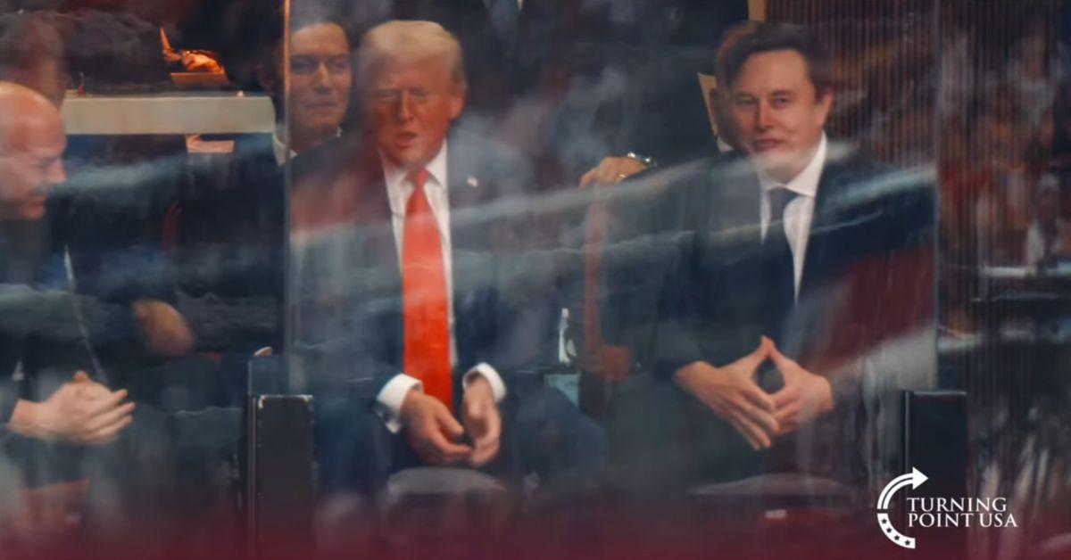 image of Donald Trump and Elon Musk sat together at Charlie Kirk’s memorial.