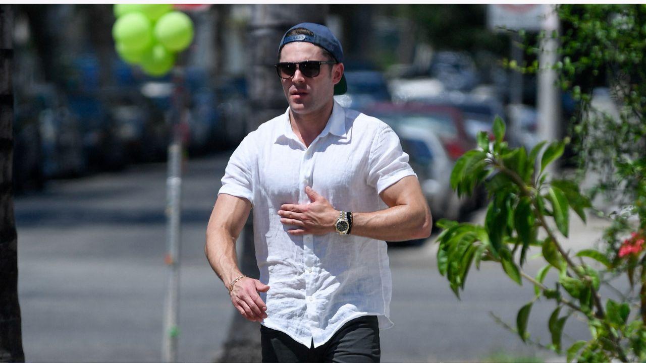 Image of Efron walking outdoors