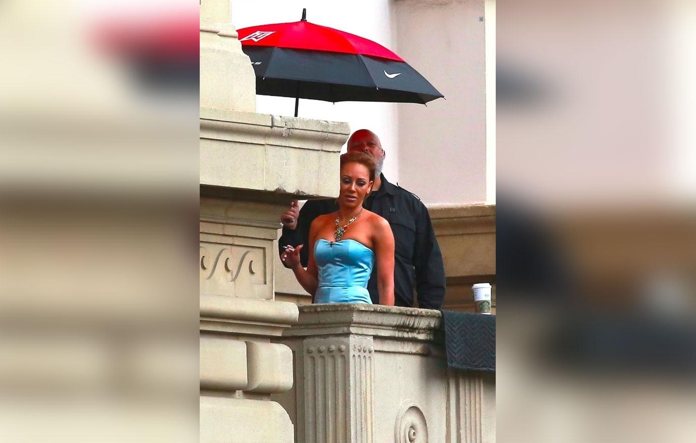 Mel B makes sure she smells good during a cigarette break