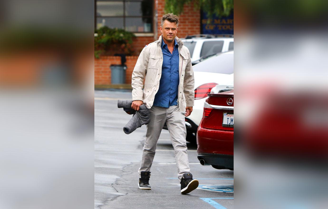 Josh Duhamel stays dry on his rainy Sunday morning