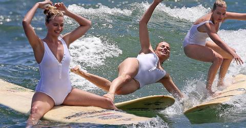 suicide squad margot robbie wipes out surfing sexy white one piece bathing suit