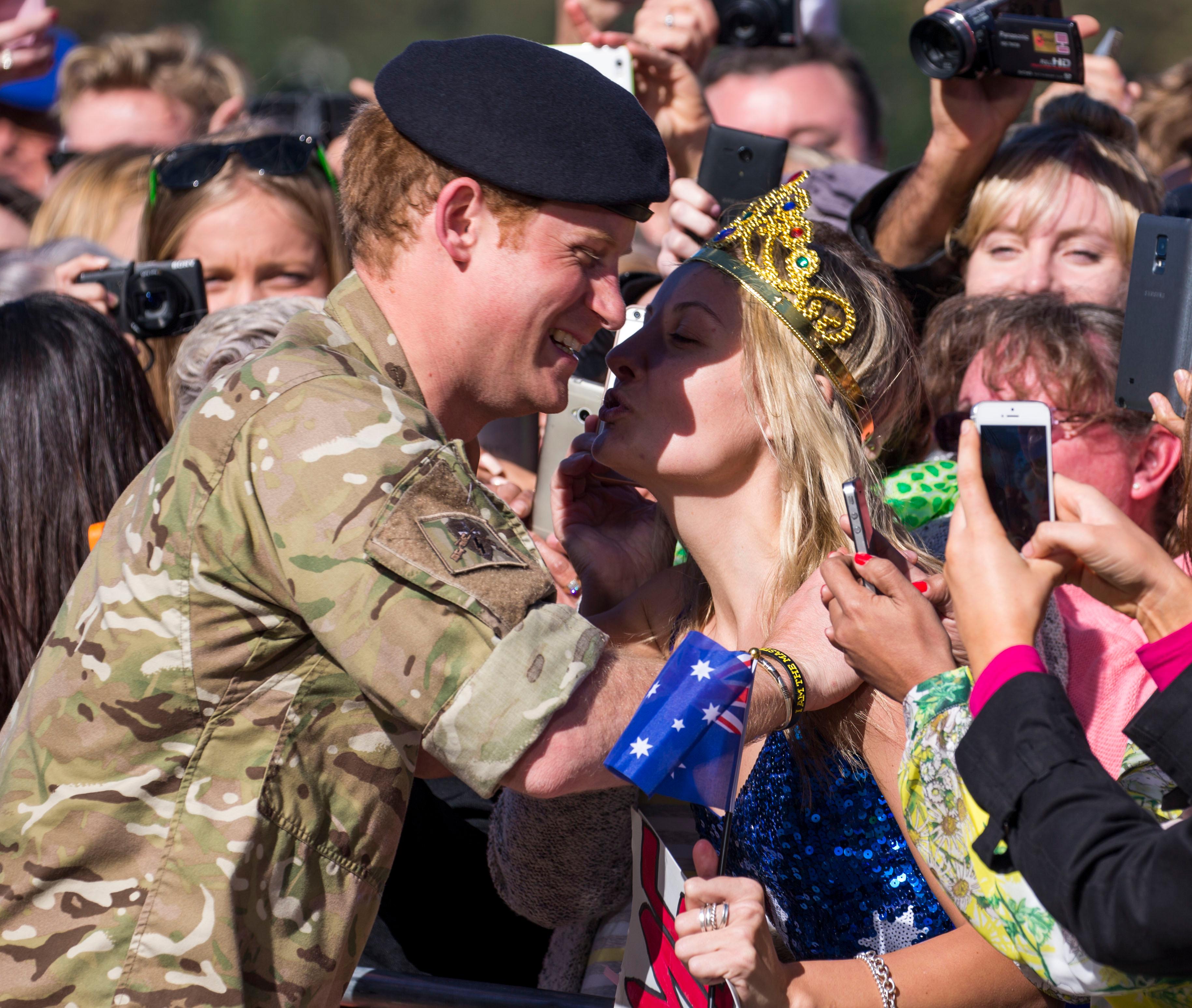 Prince Harry plants a kiss on an adoring fan! **USA ONLY**