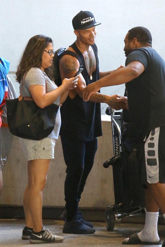 Jeremy Meeks hauls a huge cart of luggage through LAX