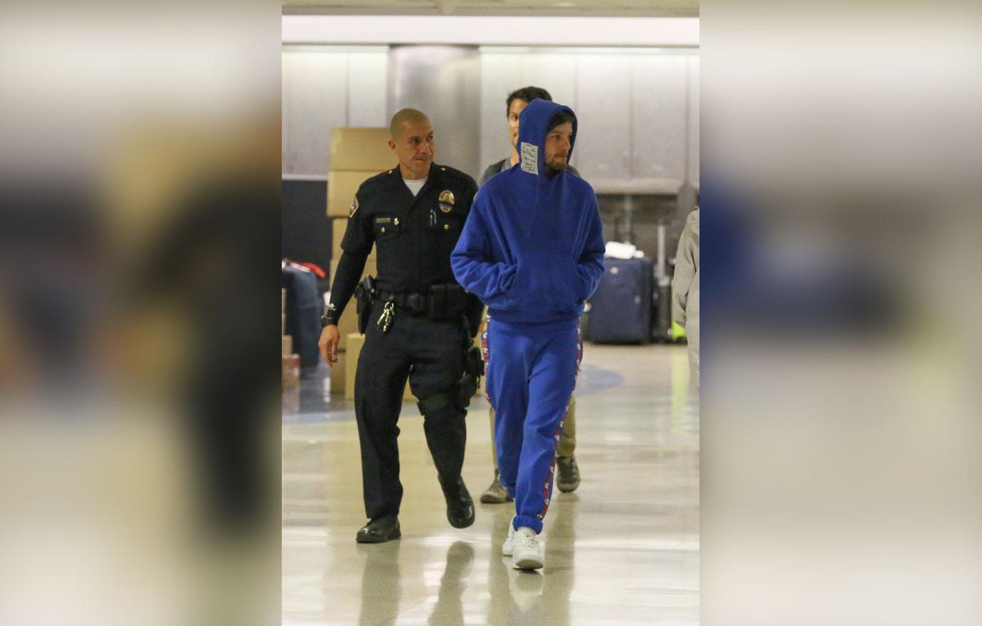 Louis Tomlinson airport arrest blue hoodie 08