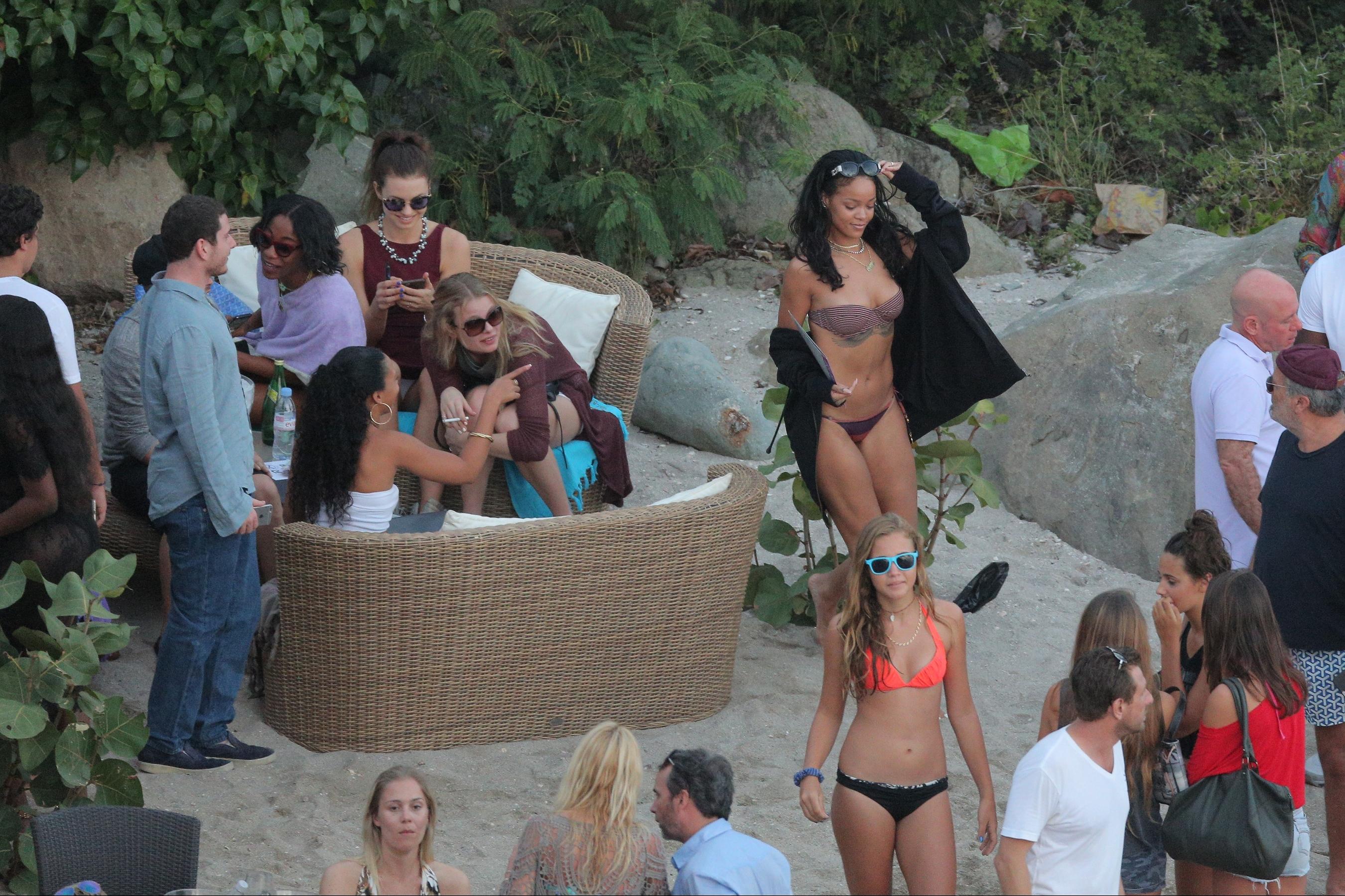 Rihanna seen partying on Shell Beach by Do Brasil beach bar