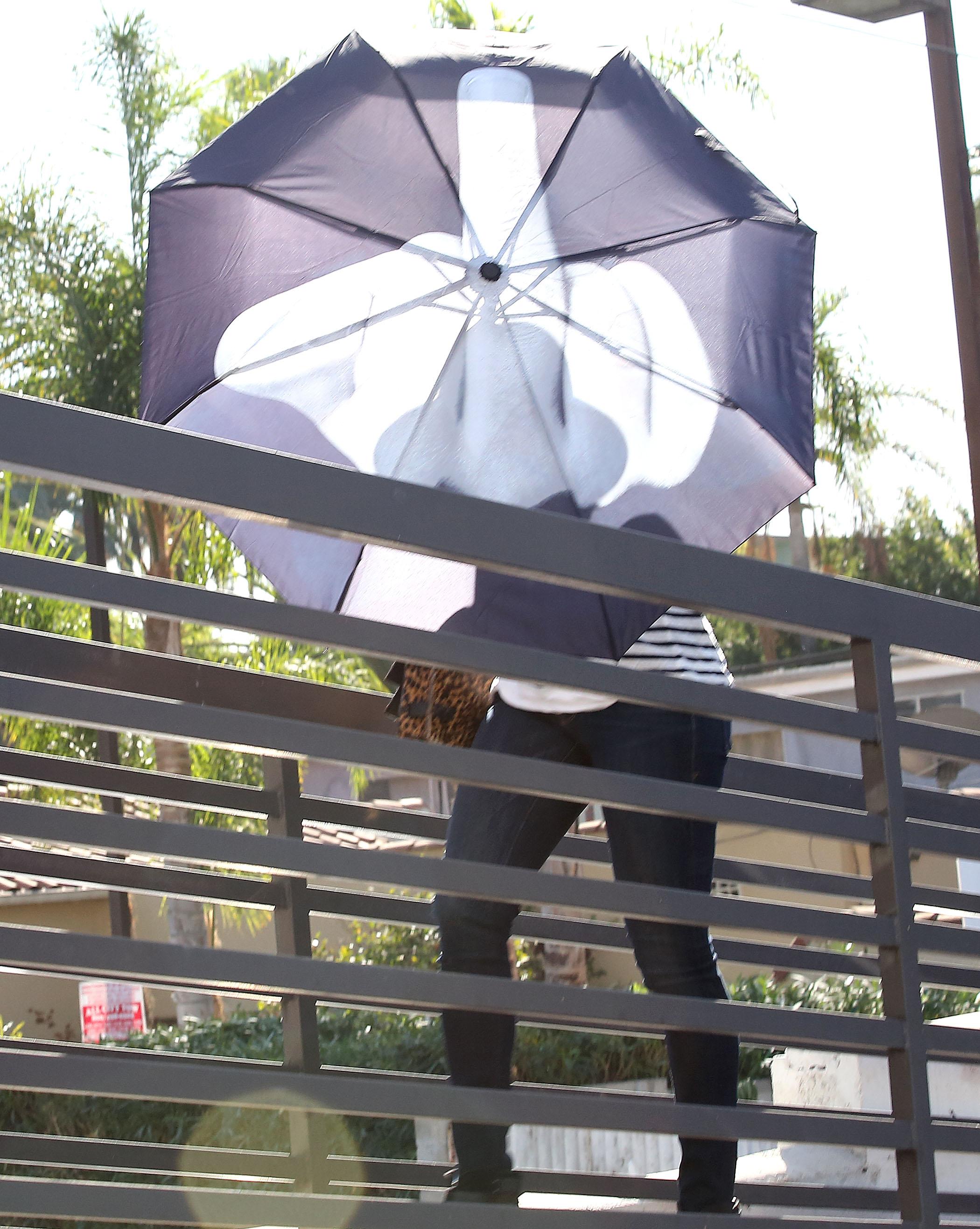 Jennifer Lawrence shows the photographers the middle finger through her new umbrella while visiting Rachel Zoe&#8217;s office in West Hollywood