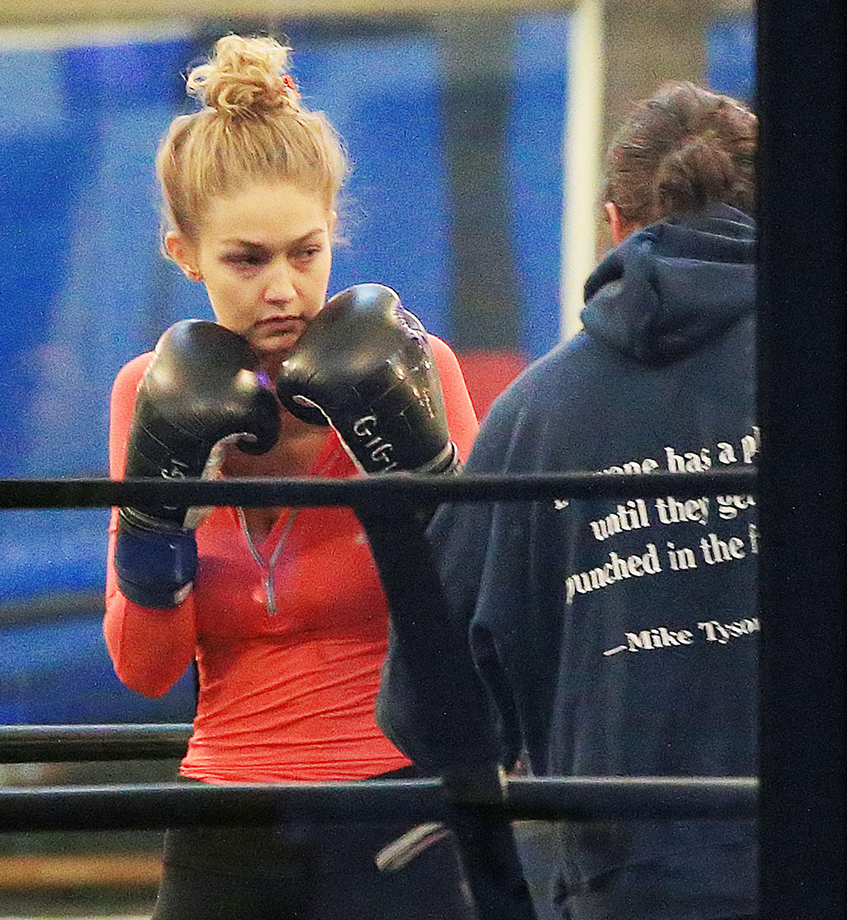 Gigi Hadid lands an uppercut on  her trainer at the boxing gym during a workout in NYC