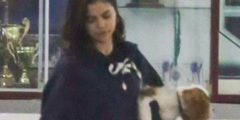 Selena Gomez holding her dog at Justin Bieber's hockey game